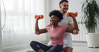 Young couple exercising together at home